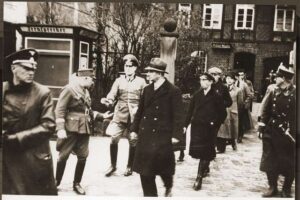 Nazi officials rounding up Jews after Kristallnacht.